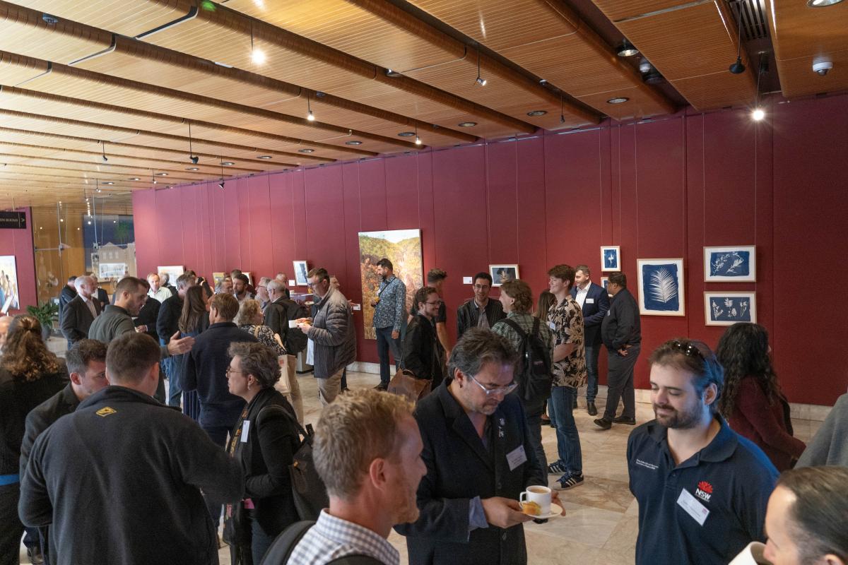 A group of people mingling and chatting during a break at event.